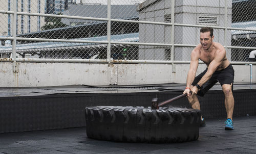 Man training at rooftop gym in bangkok