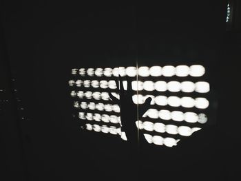 Close-up of illuminated lamp in darkroom