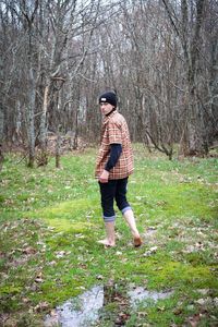 Full length of smiling man in forest