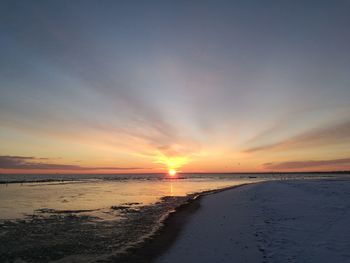 Scenic view of beach against sky during sunset