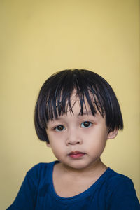 Portrait of boy against wall