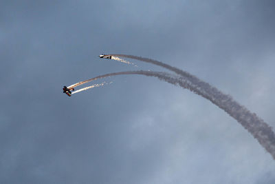 Low angle view of airplane flying against sky