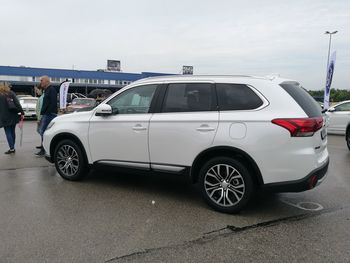 Car parked on road against sky in city