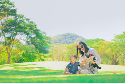 Full length portrait of mother and son on dirt road