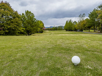 View of golf ball on field against sky