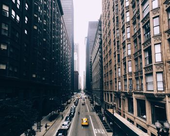 High angle view of cars on road along buildings