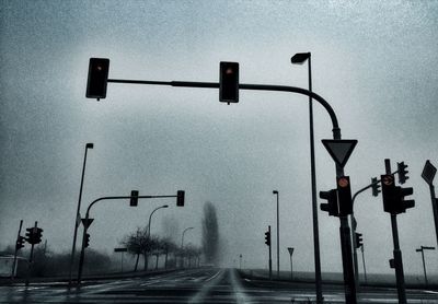 Illuminated street light against sky