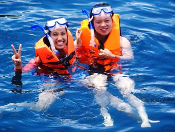 Portrait of smiling young woman in sea