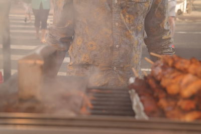 Close-up of man working in tray