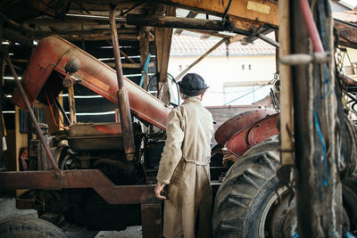 Old worker in uniform tests an excavator