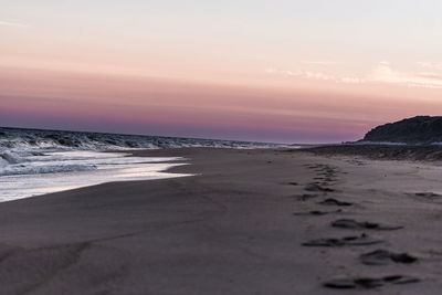 Scenic view of beach against sky during sunset
