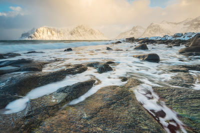 Panoramic shot of rocks on beach against sky