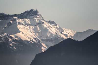 Scenic view of snowcapped mountains against clear sky