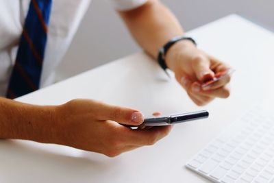 Close-up of man using mobile phone