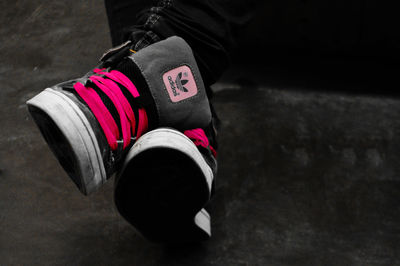 Low section of person with pink shoes
