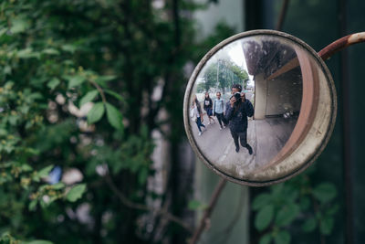 Reflection of woman photographing in mirror