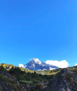 Scenic view of snowcapped mountains against clear blue sky