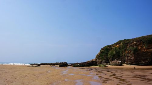 Scenic view of beach against clear sky