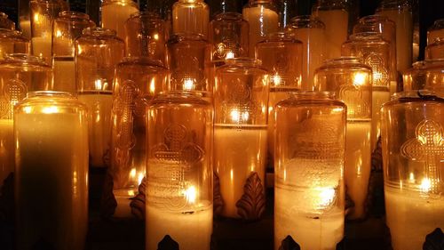 Illuminated tea light candles in darkroom