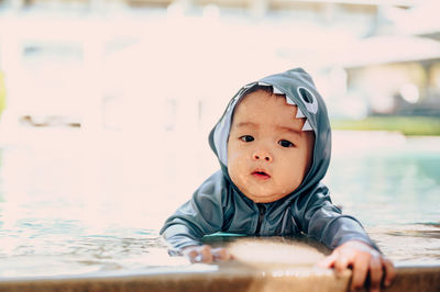 Portrait of cute boy in swimming pool