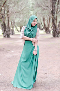 Young woman in hijab standing at park