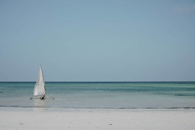 Sailboat on sea against clear sky