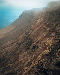 High angle view of a cliff againts clouds. lanzarote.