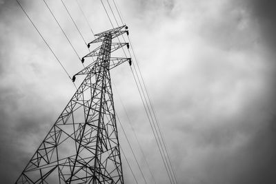 Low angle view of electricity pylon against sky