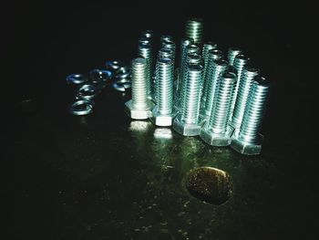 Close-up of illuminated lamp over black background