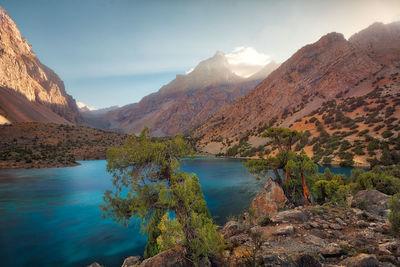 Scenic view of lake and mountains against sky