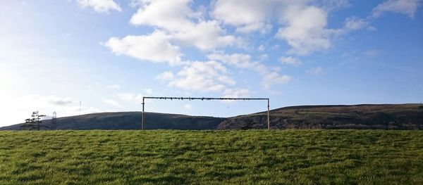 Windmill on grassy field