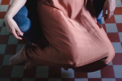 Low section of woman sitting on floor