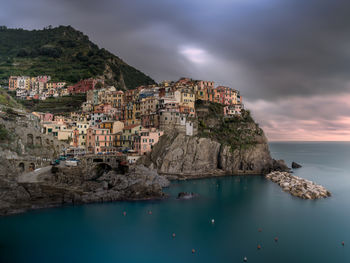 High angle view of townscape by sea against sky