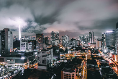 Illuminated menara kuala lumpur tower in city at night