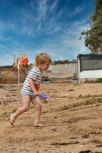 Full length of boy standing on field