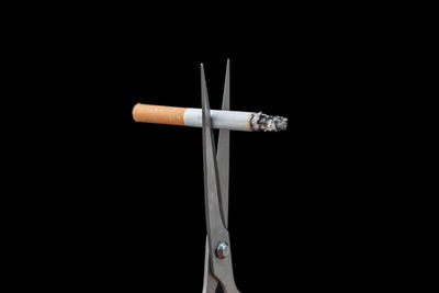 Close-up of cigarette against black background