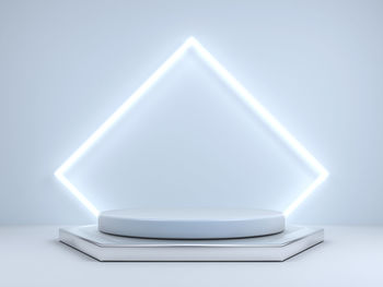 Close-up of electric lamp on table against white background