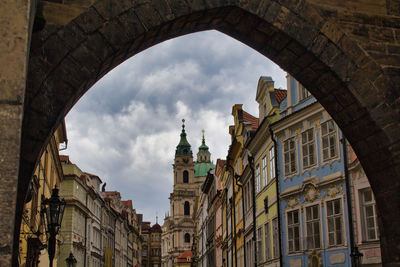 Low angle view of buildings against cloudy sky