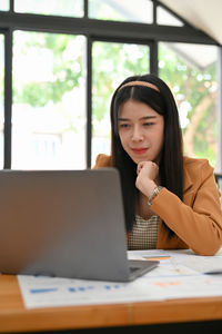 Businesswoman using laptop at office