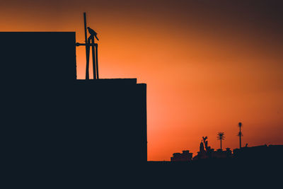 Silhouette of built structure at sunset