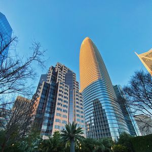 Low angle view of modern buildings against clear blue sky