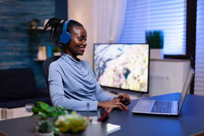 Side view of businesswoman working in office