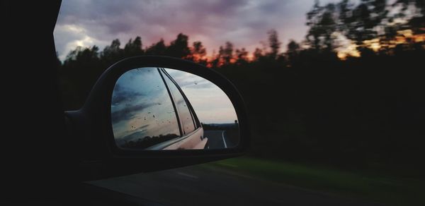 Reflection of sky on side-view mirror