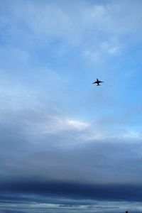 Low angle view of airplane flying in sky