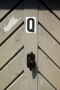 Letter q on brown door