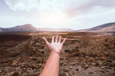 Cropped hand of man reaching sky