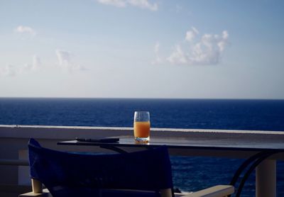 Juice on table in boat against sea