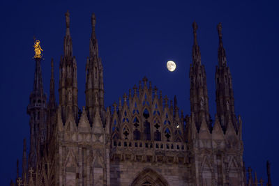 Low angle view of moon against blue sky