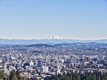 View of cityscape against blue sky