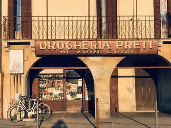 Bicycle sign on street against building